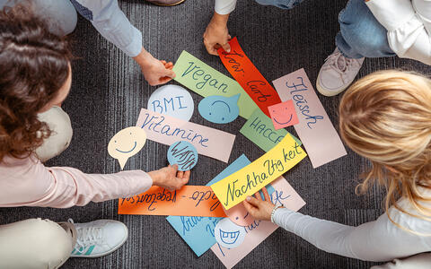 Personen in einem Workshop sortieren Themenkarten